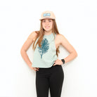 Girl wearing tank and hat with white background