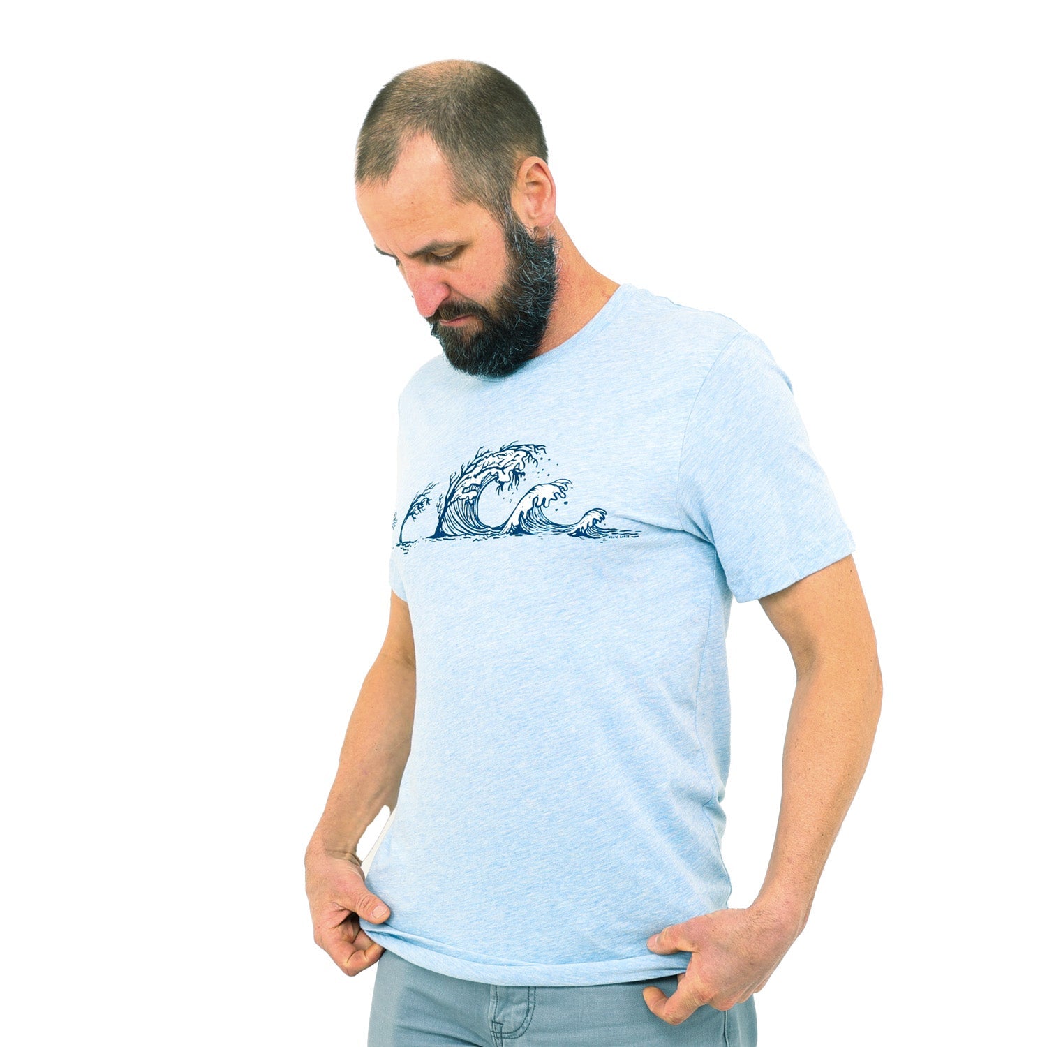 Man wearing light blue t-shirt with trees turning into waves across the chest.
