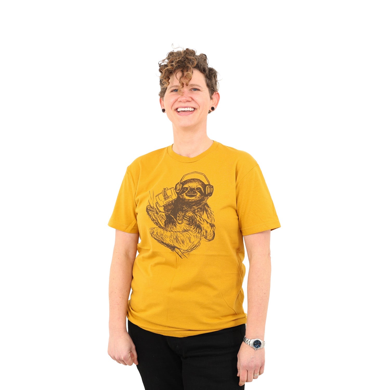 girl with awesome curly hair wearing a mustard yellow tee shirt with a sloth on it wearing headphones listening to music