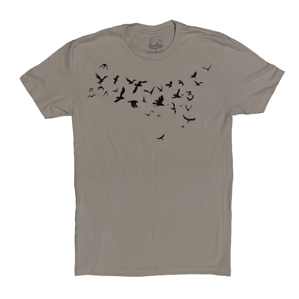 light brown/tan-ish t-shirt with black ink of birds flying across the chest of the shirt