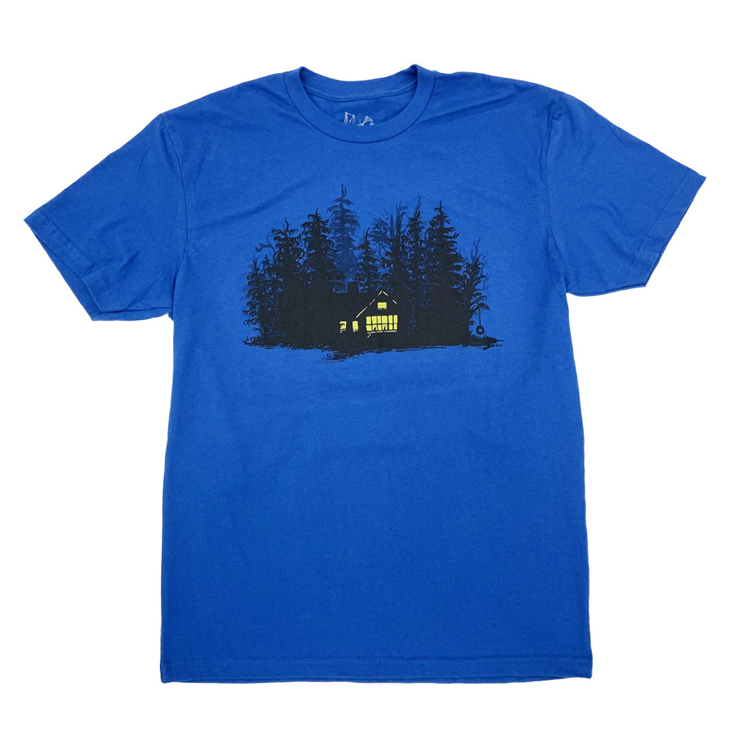 blue t-shirt with print of black ink of silhouetted trees with yellow ink house lights shining out of darkness. Two animals sitting in the window.