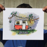Colorful art print of a Boler camper trailer held up by the corners for scale.