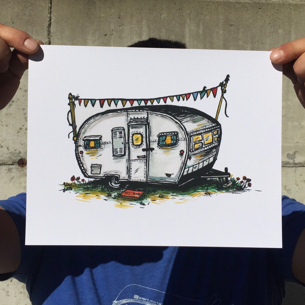 Colorful art print of a boler aero camper trailer. Print is held up by the corners by pinched fingers, for scale.