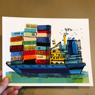 Our container ship art print in hand, for size reference.