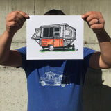 Art print painting of vintage orange Apache Mesa camper trailer, held by corners in front of man's torso, for scale.