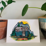 A greeting card printed with a colorful painting of a vintage bell camper trailer.