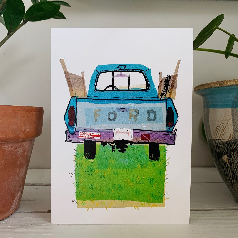 A greeting card printed with a colorful ink and tissue painting of an old blue Ford truck on a patch of grass.