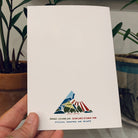 The back of a greeting card from the Island Life series, featuring the Slow Loris brand logo and address.
