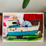 A greeting card featuring a colorful painting of an old fishing boat in  a yard. Part of our Island Life series.