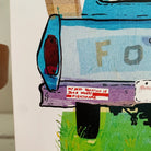 A close-up of our Old Blue Truck greeting card, on a bumper sticker that reads, My Best Vacation Is Your Worst Nightmare. Part of our Island Life series.