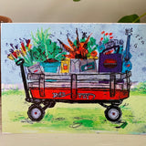 A greeting card featuring a colorful painting of a red wagon full of groceries. Part of our Island Life series.