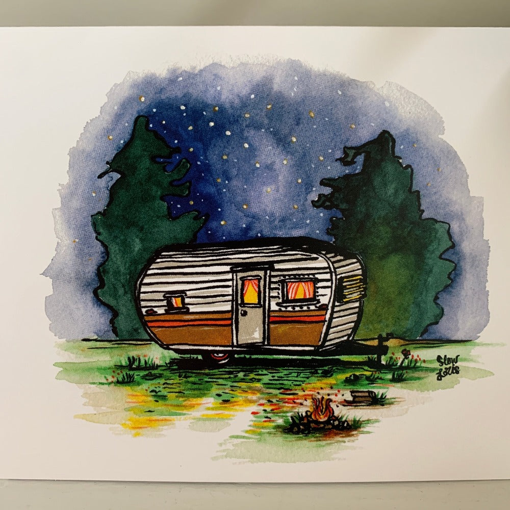 A colorful painting of an orbit trailer camper under a starry sky and trees with a campfire burning nearby. Original art used on our Orbit greeting card.