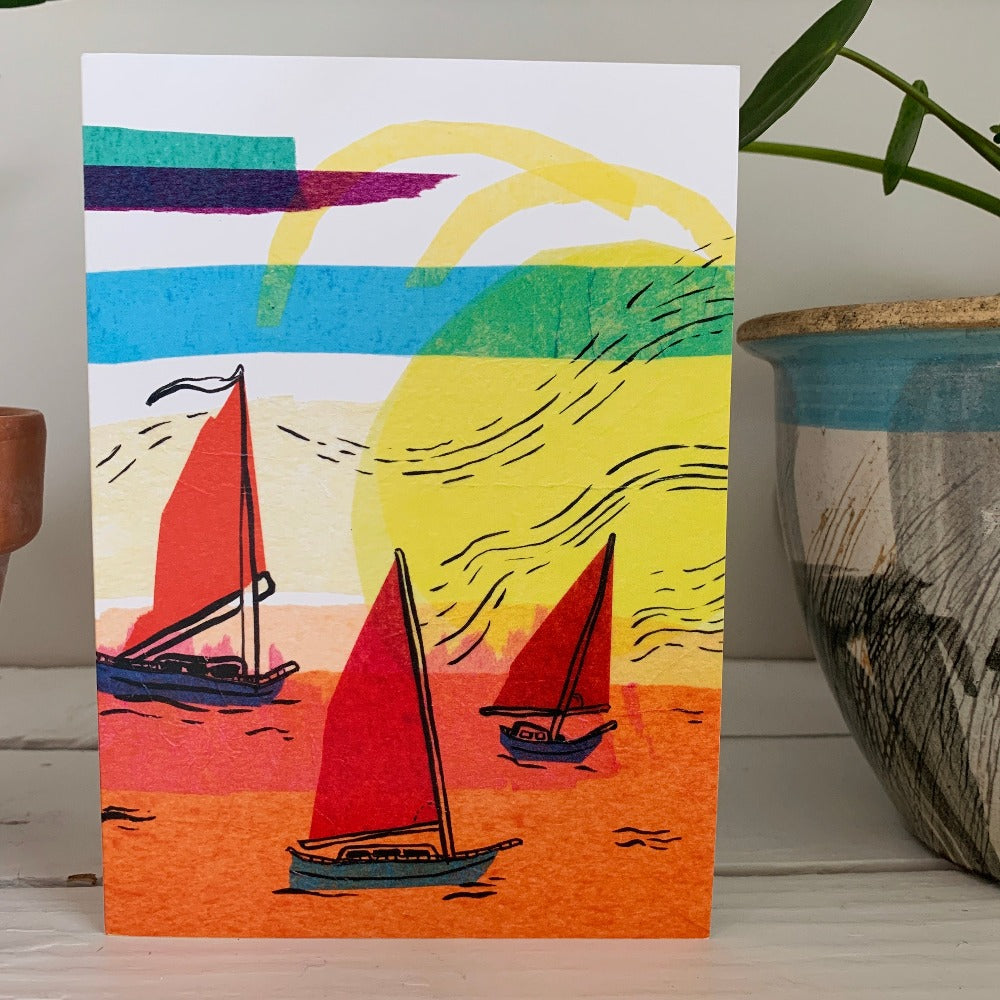 Greeting card printed with a colorful ink and tissue painting of three boats setting sail at sunset.