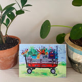 Greeting card printed with a colorful painting of a wagon full of groceries.