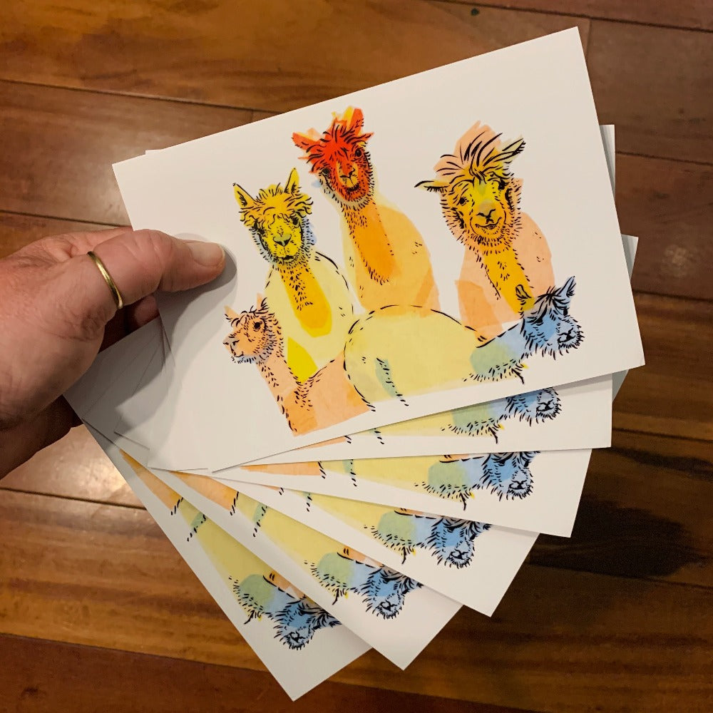 6 greeting cards printed with colorful golden alpacas.