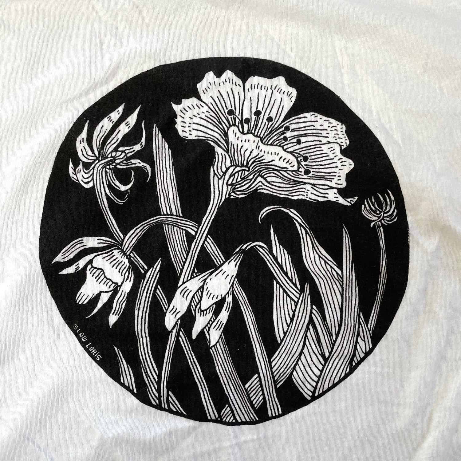Close up of white t shirt with black ink of an Even Star Flower