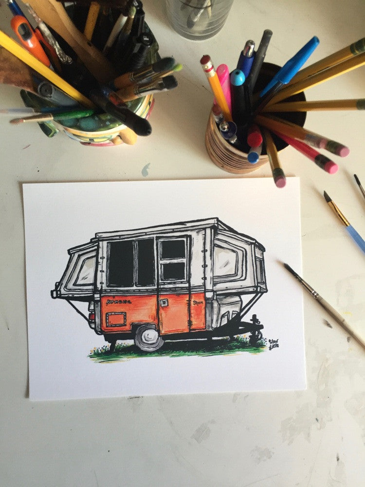 Original painting of vintage camper trailer sitting on desk with pens and brushes.