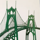 Close-up detail of a postcard printed with a two-tone green painting of the St Johns Bridge in Portland, Oregon.
